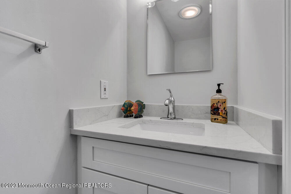 303 Salem Avenue Spring Lake, NJ 07762 - Photo 22 of 38 a bathroom with a sink and a mirror
