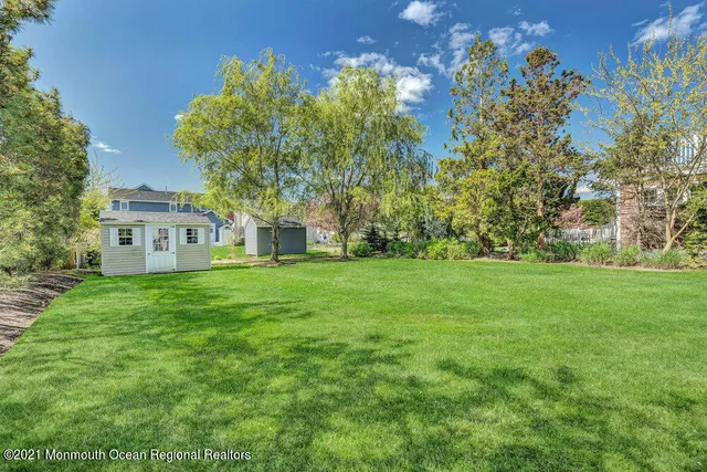 a view of house with garden space and trees