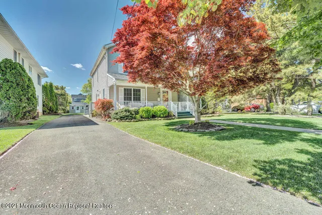 a front view of house with yard and green space