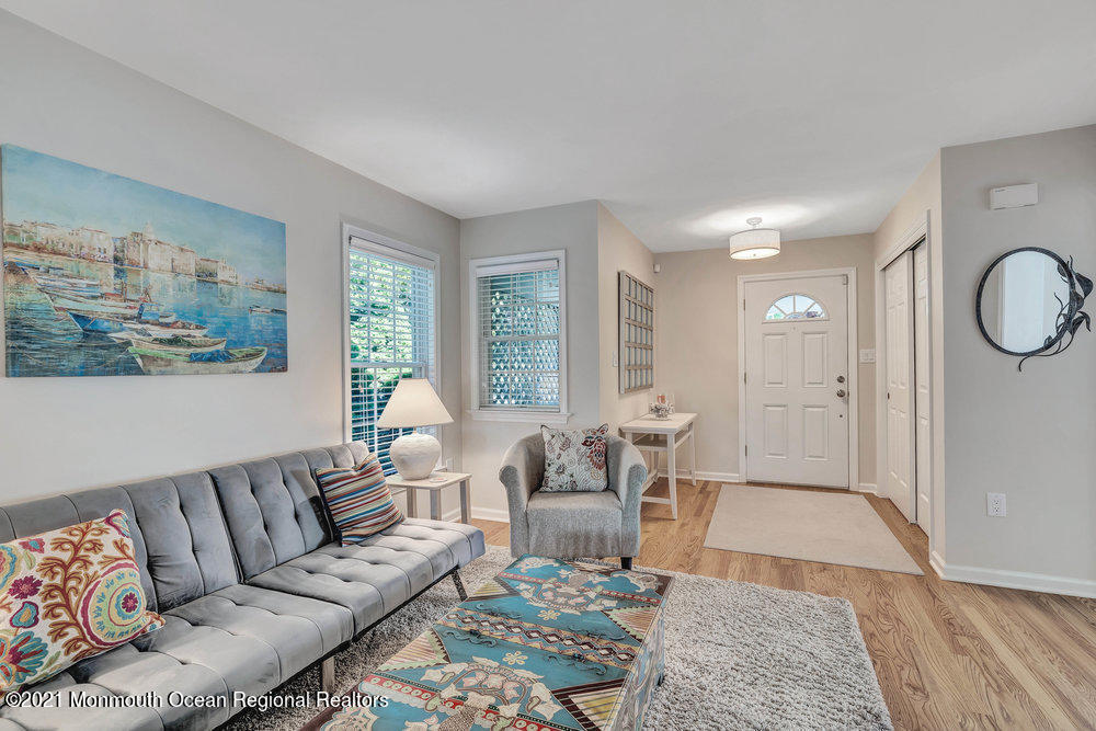 303 Salem Avenue Spring Lake, NJ 07762 - Photo 9 of 38 a living room with furniture wooden floor and a large window