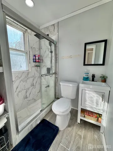 a bathroom with a toilet and a shower