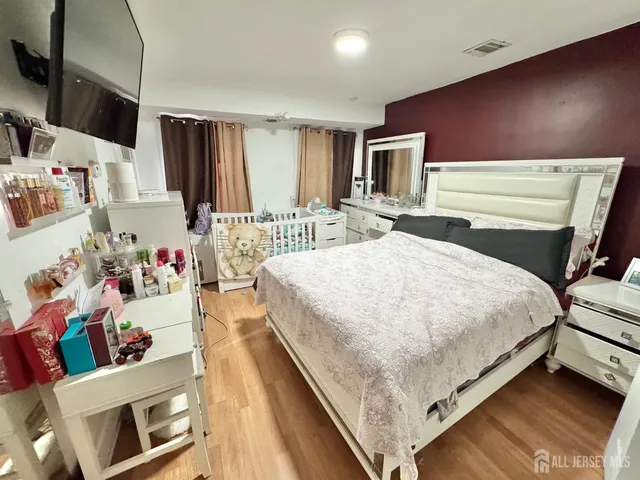 a bed room with a bed and a television