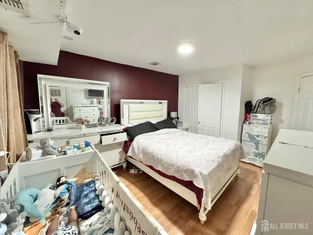 a bed room with a bed and two chair