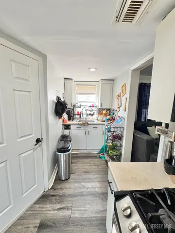 a room with furniture a flat screen tv and a window