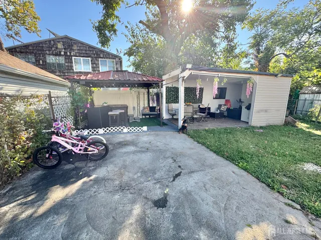 a view of a house with yard and sitting area
