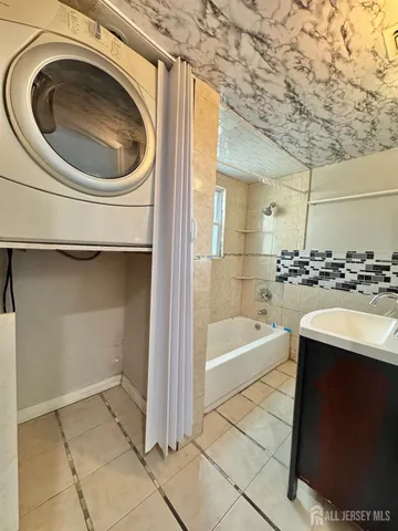 a kitchen with a refrigerator a stove top oven and wooden floor