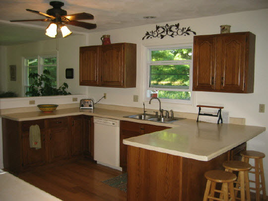 13795 Cook Road Pecatonica, IL 61063 - Photo 8 of 11 a kitchen with a sink a window and cabinets