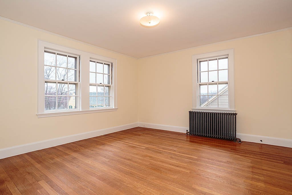 79 Douglas Road Belmont, MA 02478 - Photo 12 of 17 an empty room with wooden floor and windows