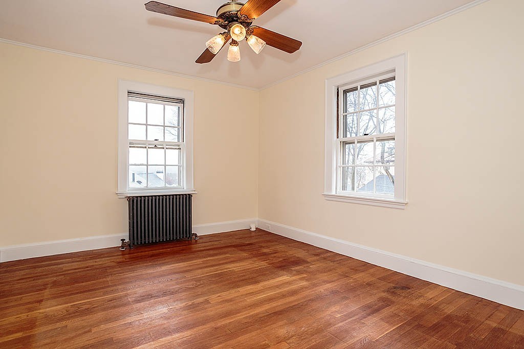 79 Douglas Road Belmont, MA 02478 - Photo 13 of 17 an empty room with wooden floor chandelier fan and windows