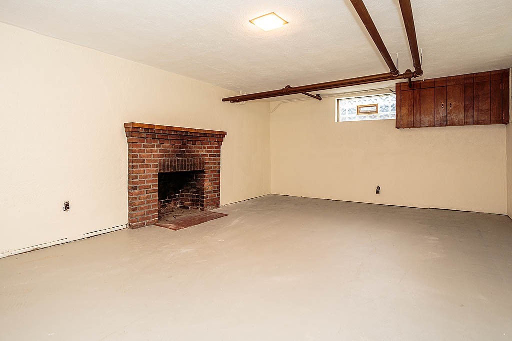 79 Douglas Road Belmont, MA 02478 - Photo 15 of 17 a view of an empty room with a fireplace