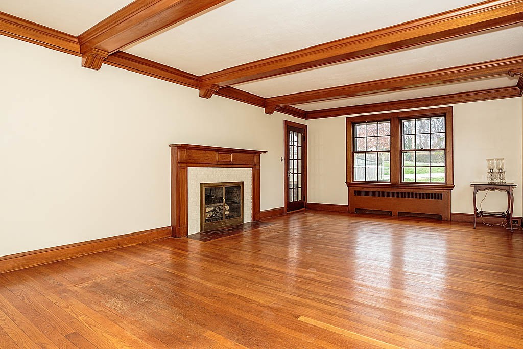 79 Douglas Road Belmont, MA 02478 - Photo 3 of 17 a view of empty room with wooden floor and fireplace