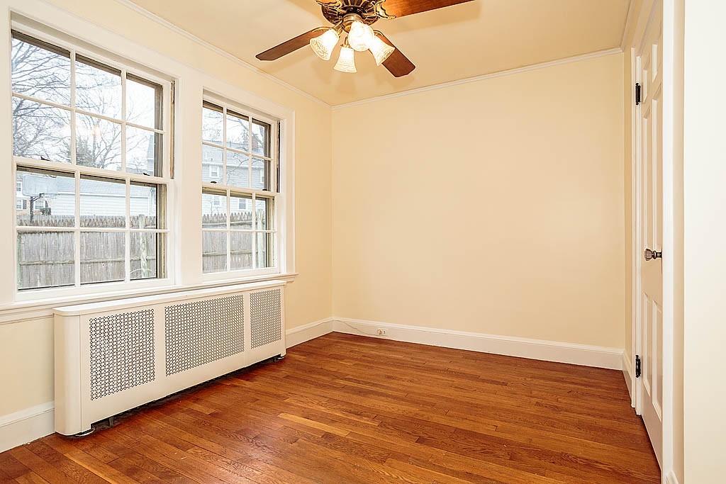 79 Douglas Road Belmont, MA 02478 - Photo 8 of 17 a view of an empty room with wooden floor and a window