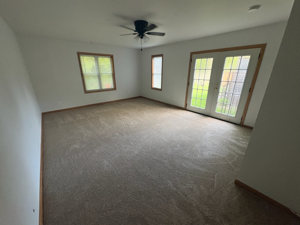 1605 Highway 47 Morris, IL 60450 - Photo 14 of 21 an empty room with windows and chandelier fan