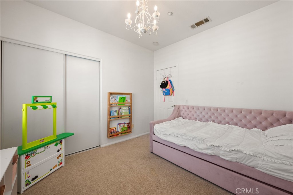 6 Lynde Street Ladera Ranch, CA 92694 - Photo 28 of 35 a bedroom with a bed and a chandelier