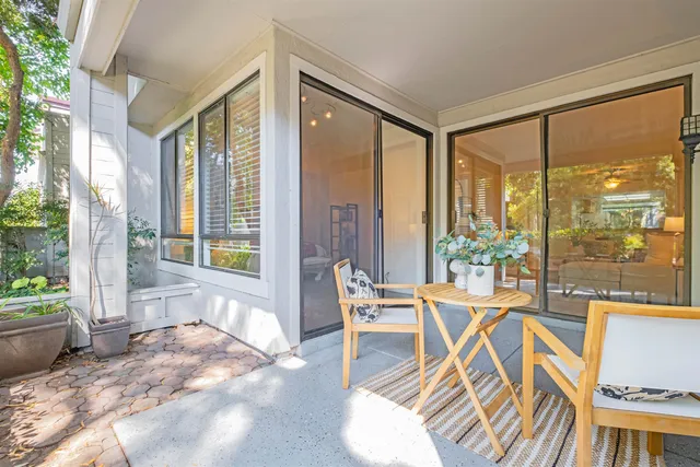 a view of a room with a large window and furniture