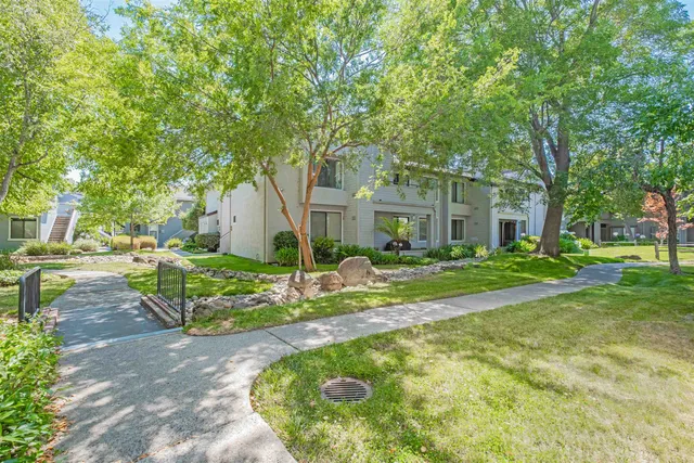 a view of house with backyard and garden