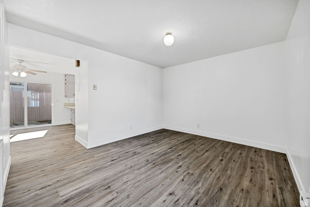 283 West 600 North, Unit 2 Logan, UT 84321 - Photo 8 of 36 Spacious interior room featuring wood-finish flooring, white baseboards, and a neutral wall color