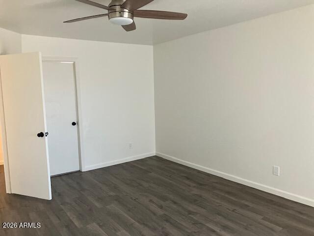 3149 East Angela Drive, Unit 2 Phoenix, AZ 85032 - Photo 9 of 17 an empty room with wooden floor and ceiling fan