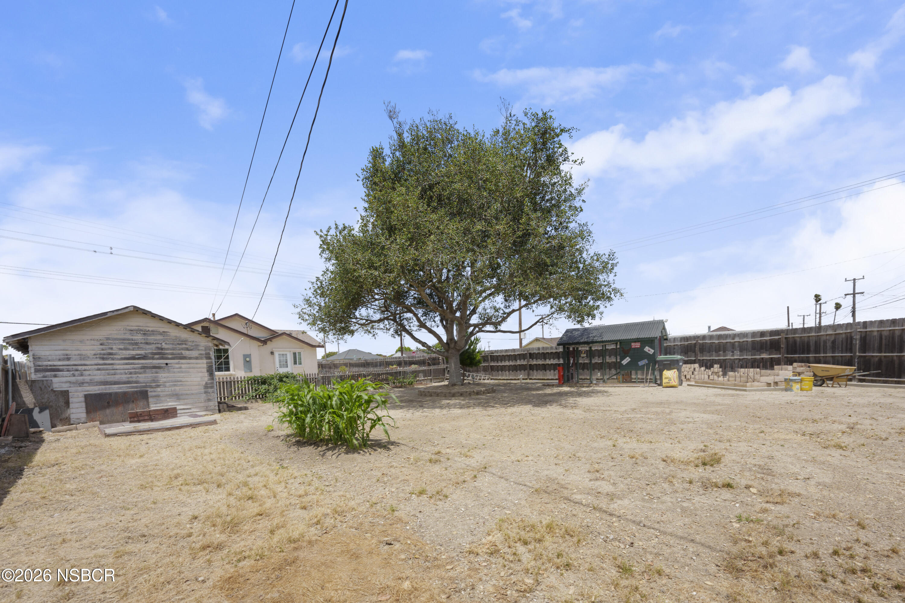 138 North E Street Lompoc, CA 93436 - Photo 32 of 35 a view of a yard with wooden fence