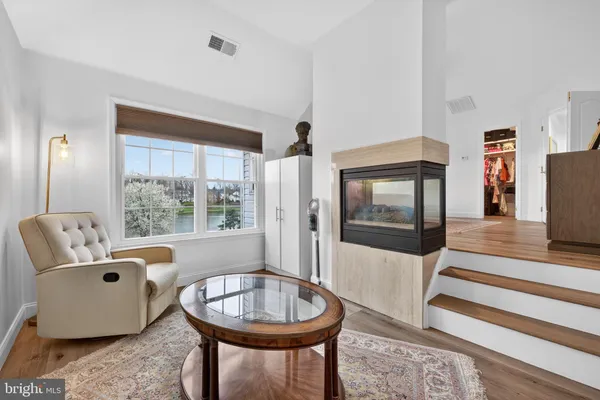 a bathroom with a granite countertop tub sink a mirror and a bathtub