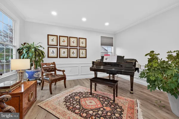 a dining room with furniture a chandelier and wooden floor