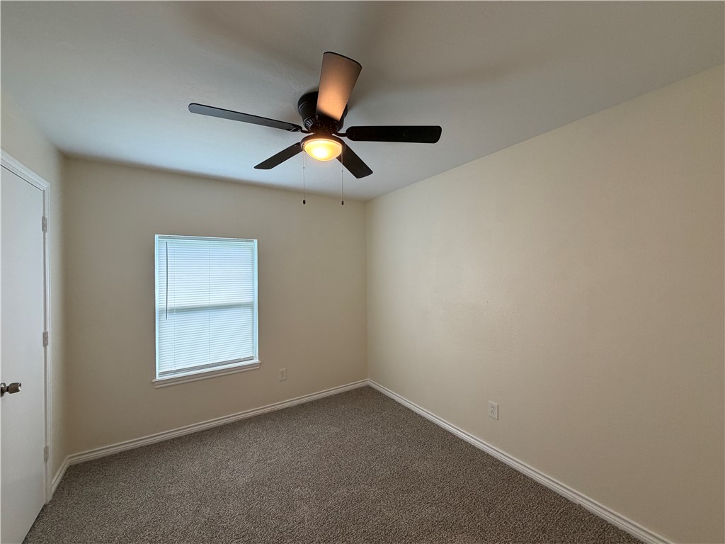 306 West 23rd Street Bryan, TX 77803 - Photo 5 of 12 an empty room with a window and a fan