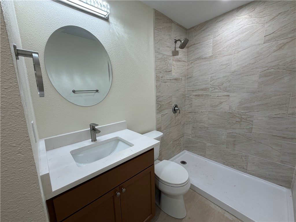 306 West 23rd Street Bryan, TX 77803 - Photo 9 of 12 a bathroom with a sink a toilet and shower