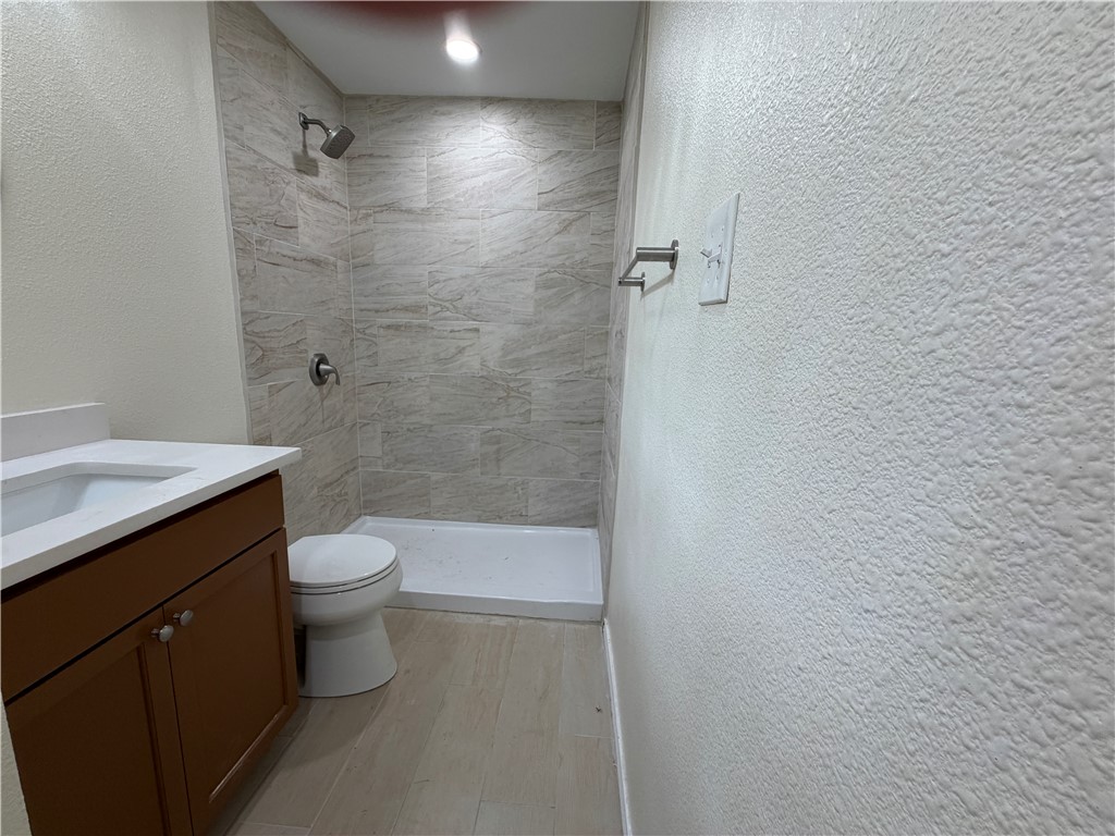 306 West 23rd Street Bryan, TX 77803 - Photo 10 of 12 a bathroom with a toilet a sink and shower