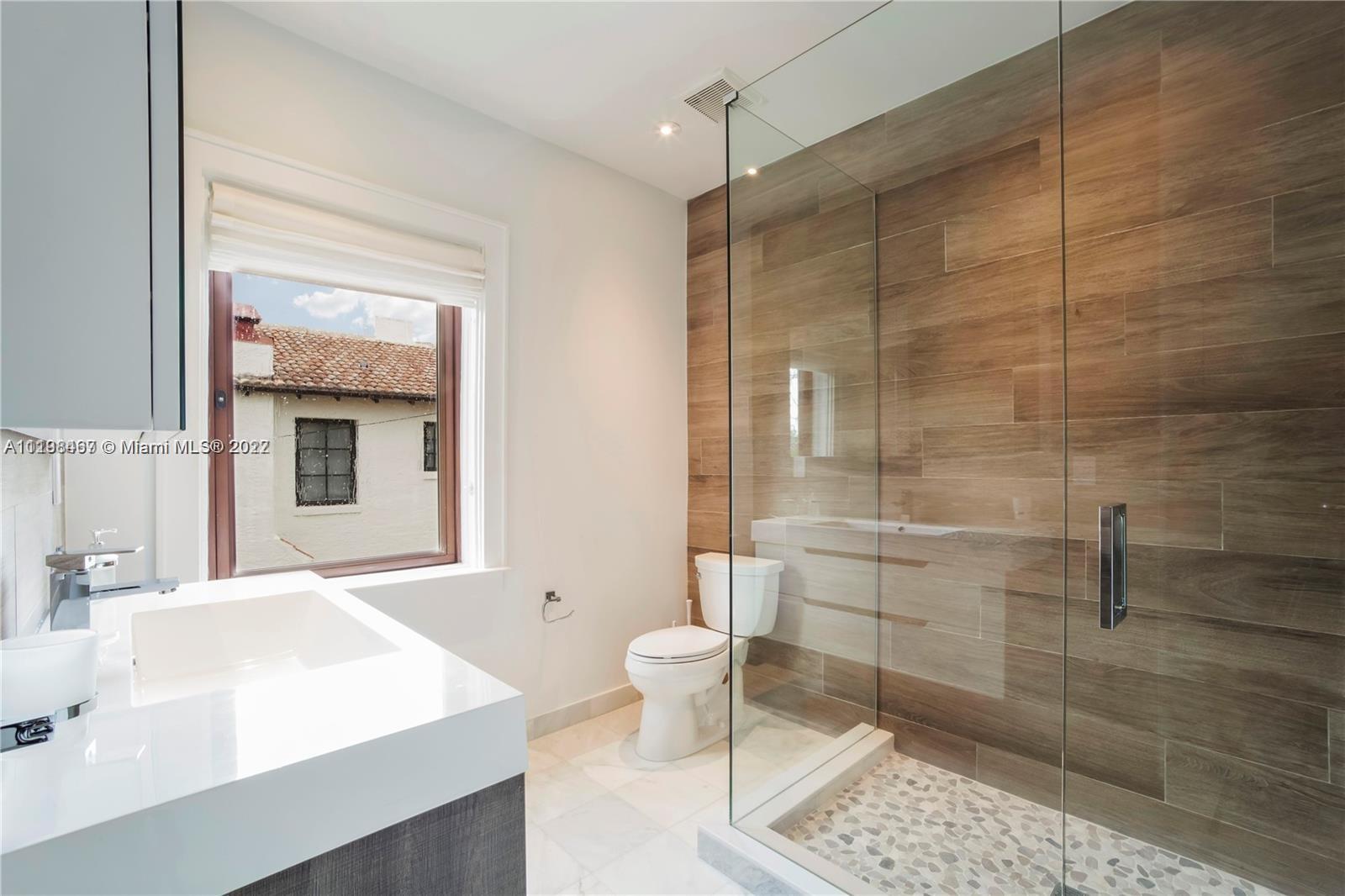 5768 Pine Tree Drive Miami Beach, FL 33140 - Photo 17 of 17 a bathroom with a sink a toilet and shower