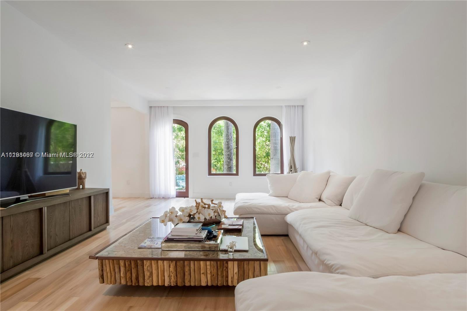 5768 Pine Tree Drive Miami Beach, FL 33140 - Photo 4 of 17 a living room with furniture and a flat screen tv