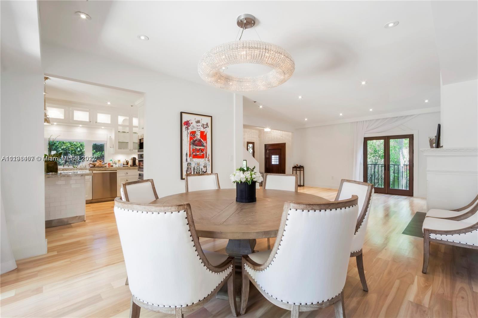 5768 Pine Tree Drive Miami Beach, FL 33140 - Photo 5 of 17 a view of a dining room with furniture window and wooden floor