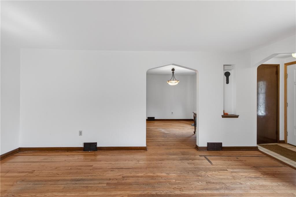 1420 Homestead Road Verona, PA 15147 - Photo 6 of 34 an empty room with wooden floor and cabinets