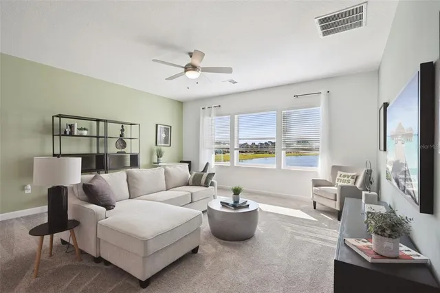 a living room with furniture and a large window