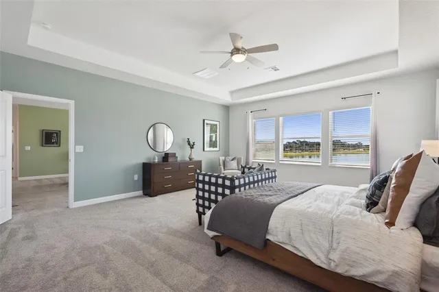 a bedroom with a bed large window with couch