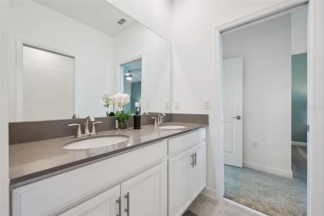 a bedroom with a bed chandelier and a window
