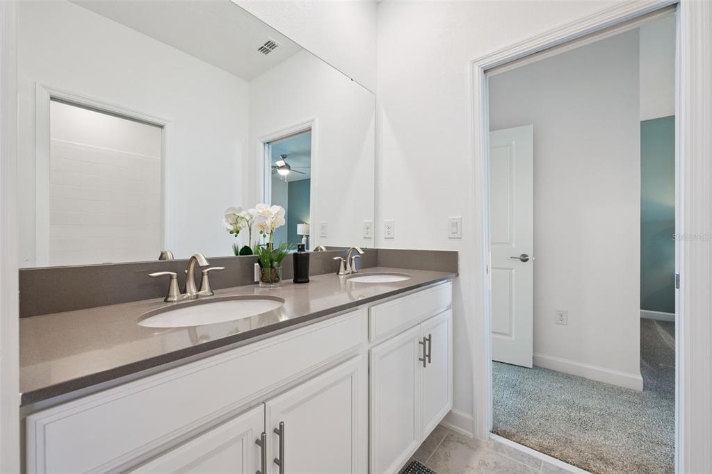 3012 Ella Way St. Cloud, FL 34771 - Photo 21 of 56 a bathroom with a sink and a mirror
