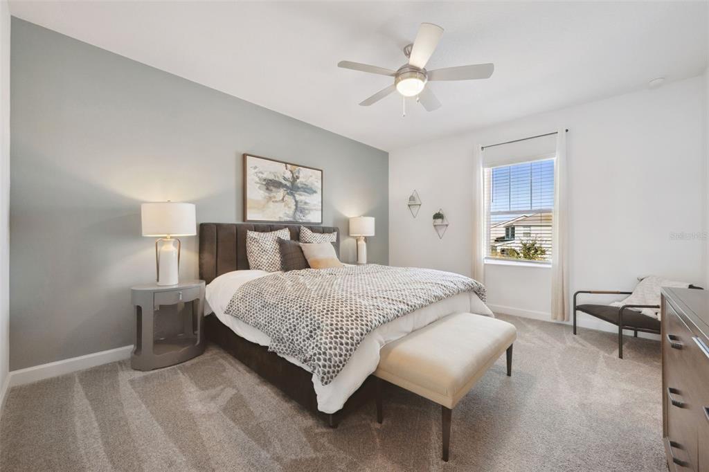 3012 Ella Way St. Cloud, FL 34771 - Photo 23 of 56 a bedroom with a bed chandelier and a window