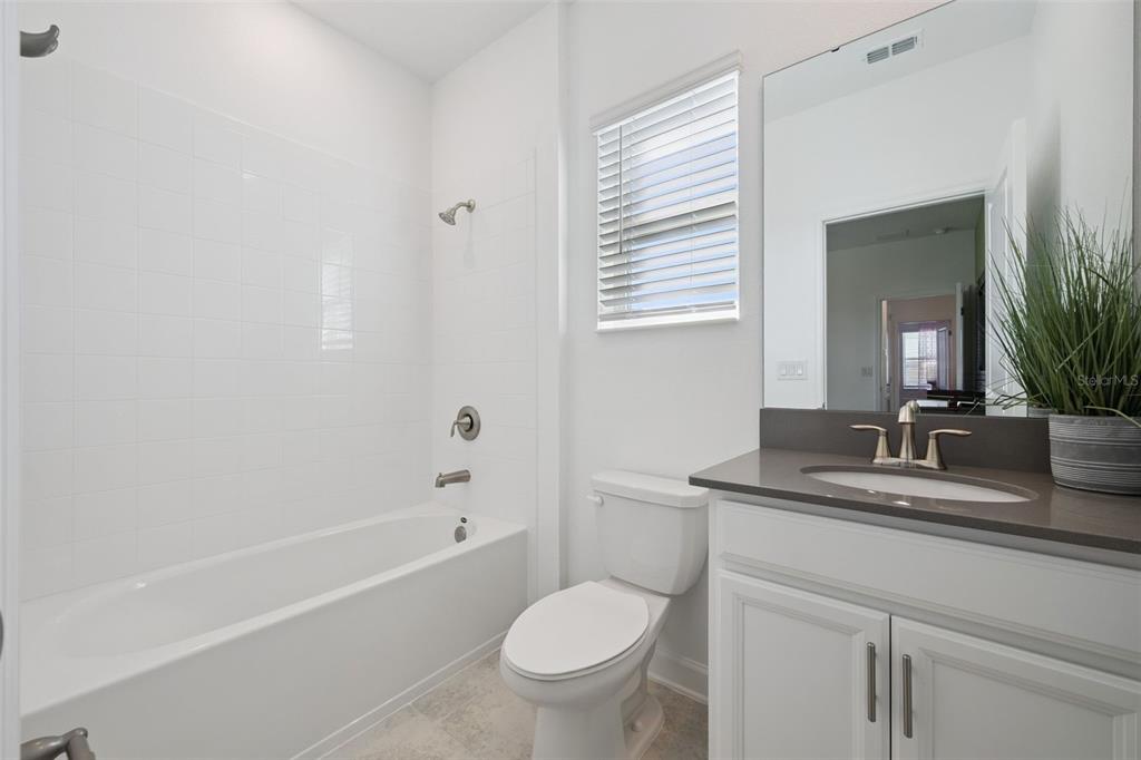 3012 Ella Way St. Cloud, FL 34771 - Photo 25 of 56 a bathroom with a toilet a sink and a bathtub