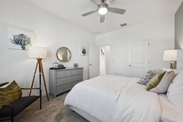 a front view of a house with a yard and green space