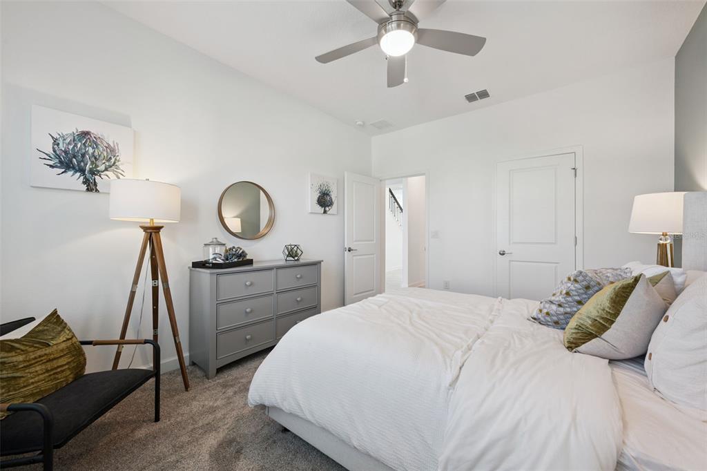 3012 Ella Way St. Cloud, FL 34771 - Photo 27 of 56 a bedroom with a bed and a chandelier