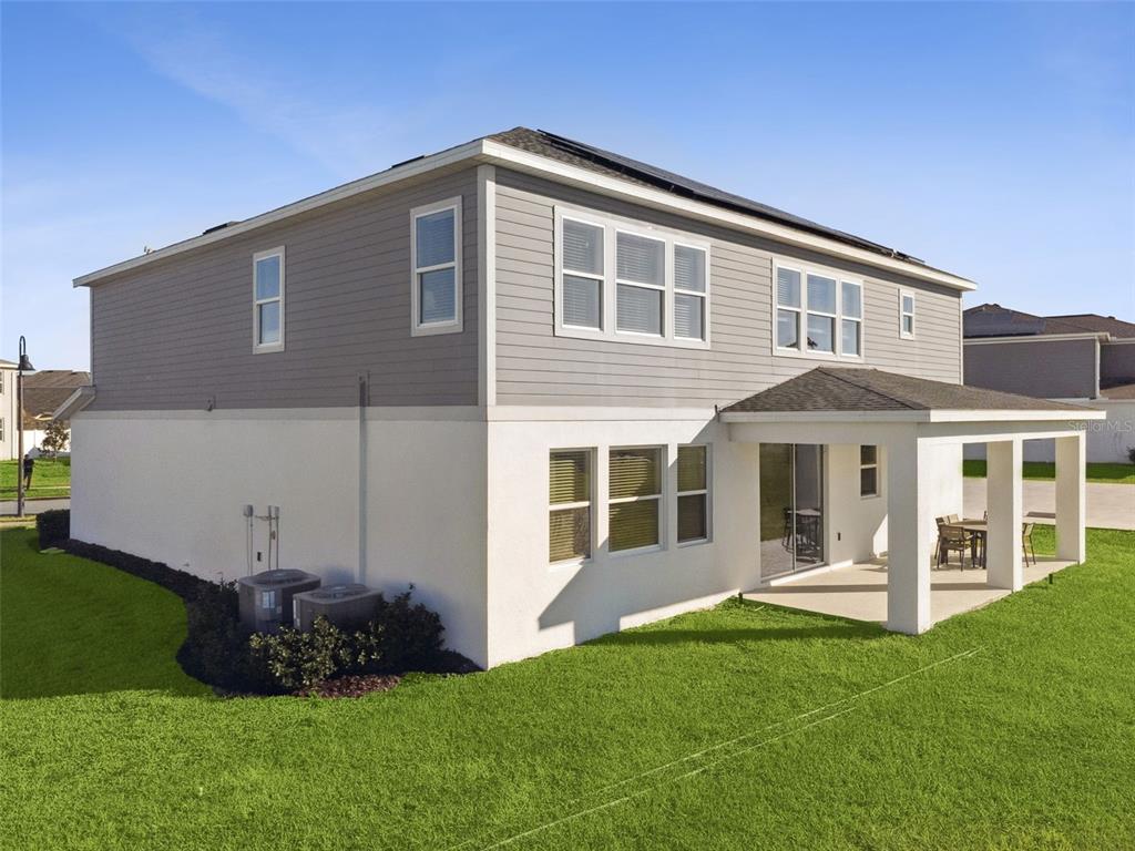 3012 Ella Way St. Cloud, FL 34771 - Photo 29 of 56 a front view of a house with a yard and green space