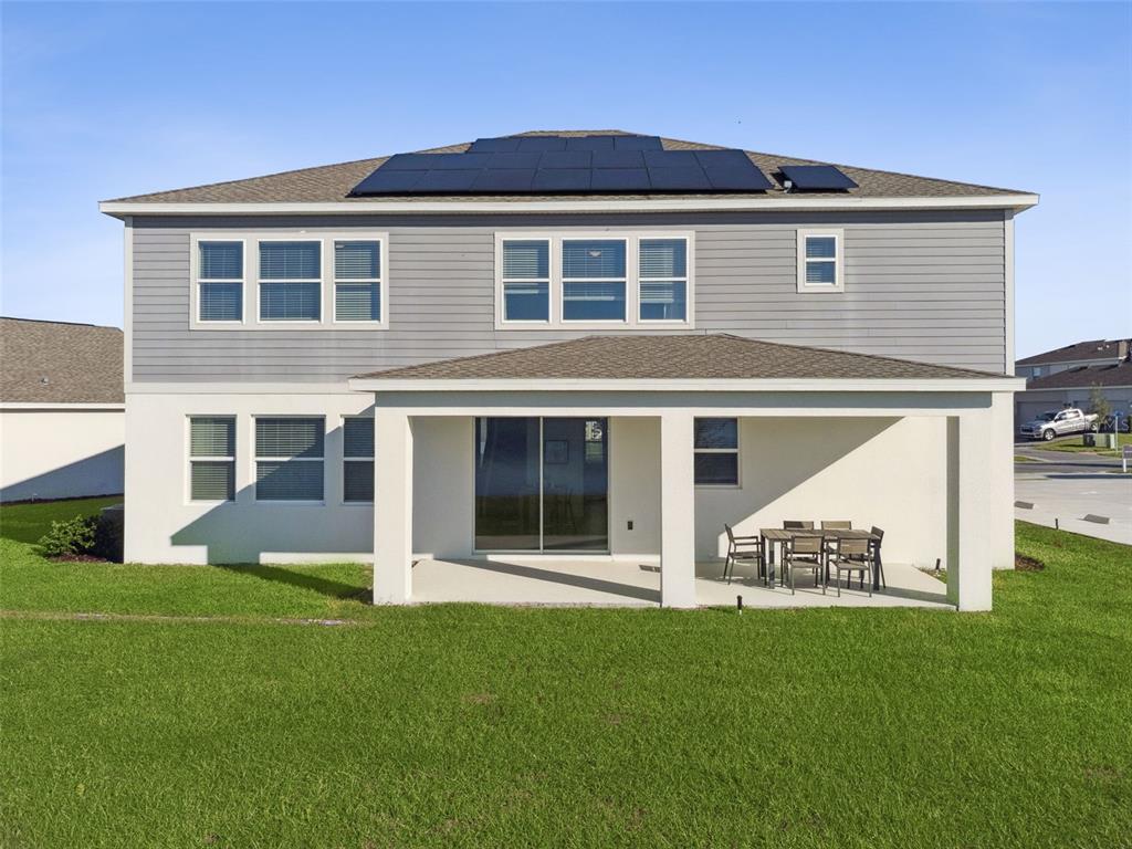 3012 Ella Way St. Cloud, FL 34771 - Photo 30 of 56 a view of a house with a yard