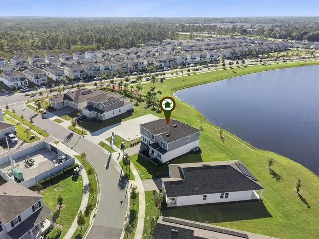 an aerial view of a houses with a swimming pool