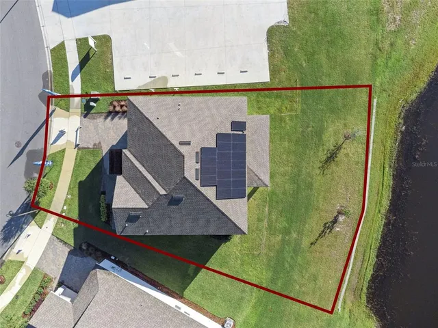 a view of house with swimming pool and outdoor seating