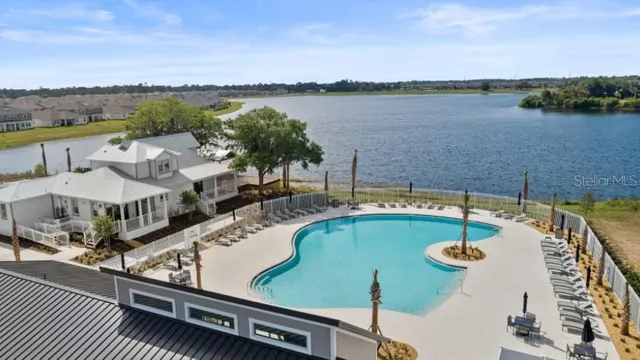 a kitchen with granite countertop a table chairs a sink dishwasher refrigerator and microwave