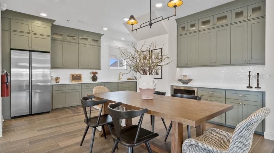 3012 Ella Way St. Cloud, FL 34771 - Photo 40 of 56 a kitchen with granite countertop a table chairs a sink dishwasher refrigerator and microwave