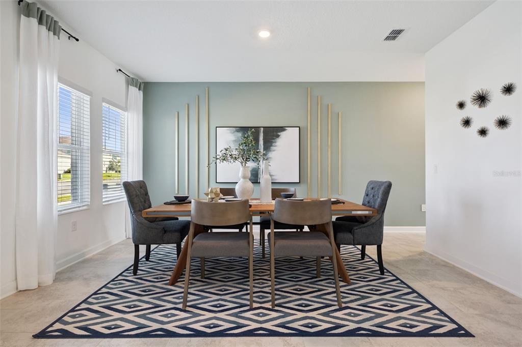 3012 Ella Way St. Cloud, FL 34771 - Photo 52 of 56 a dining room with wooden floor and a rug
