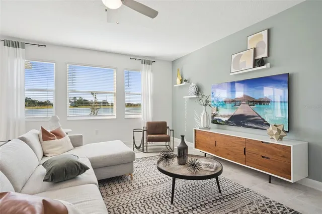 a living room with furniture and a painting on the wall