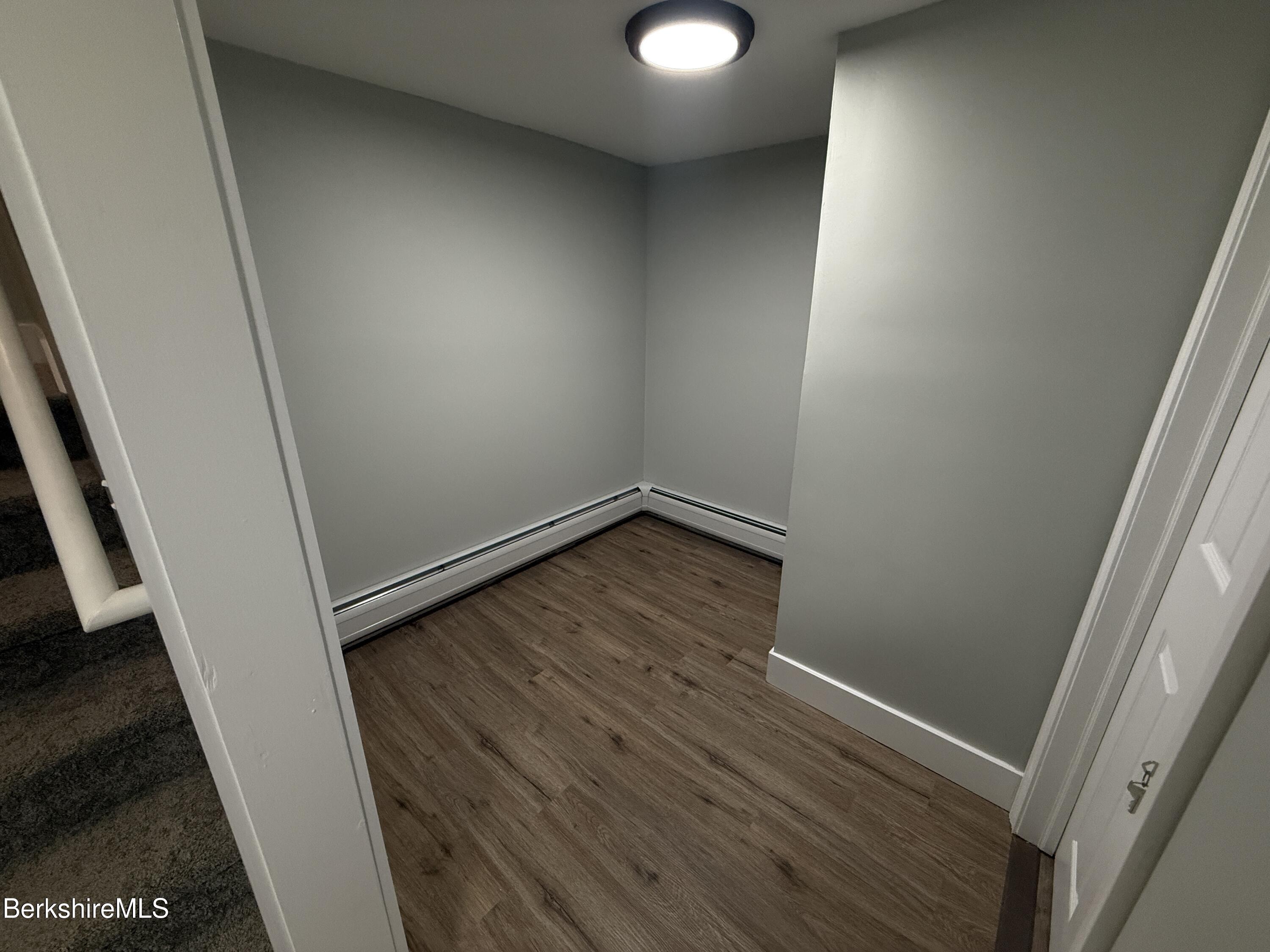 17 Elm Street, Unit A Adams, MA 01220 - Photo 12 of 17 an empty room with wooden floor and entrance