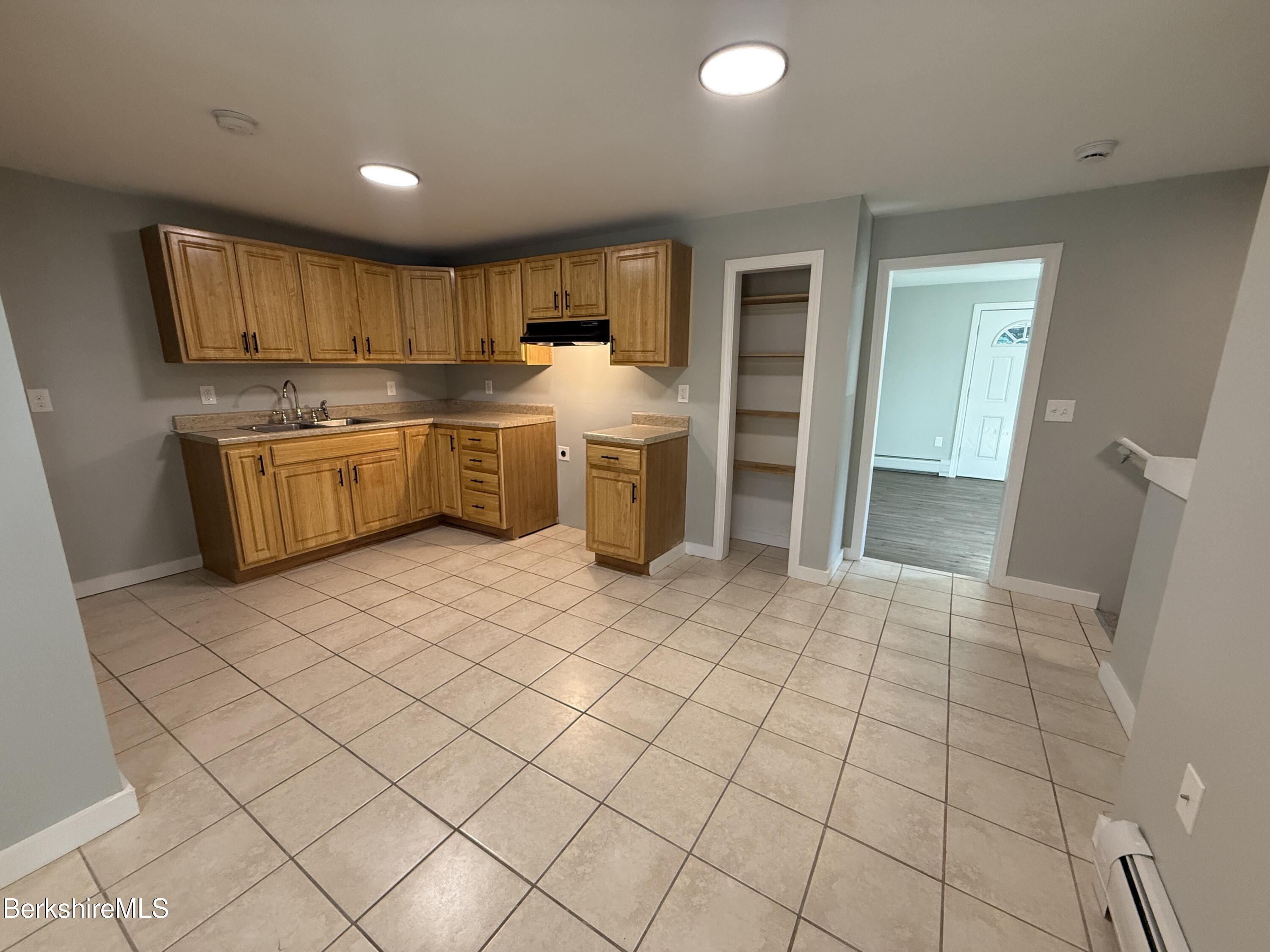 17 Elm Street, Unit A Adams, MA 01220 - Photo 4 of 17 a kitchen with a sink a stove top oven and cabinets